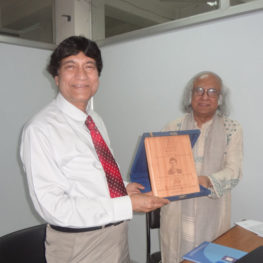 Prof. Haider A. Khan receiving an award from Dr. Qazi Kholiquzzaman Ahmad